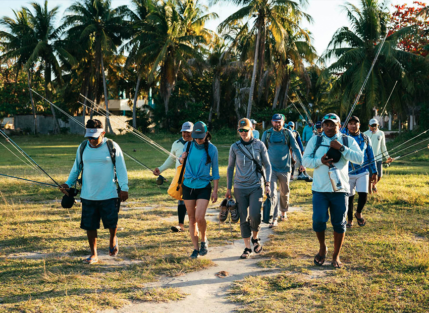 A group of fly fishermen wakling towards to Ascension Bay from Kay Fly Fishing Lodge.