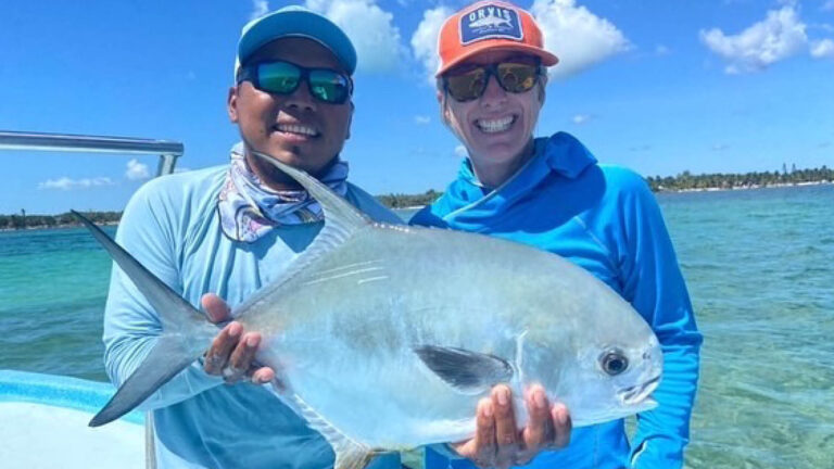 A fly fishermen catches a permit in Ascension Bay, Mexico.