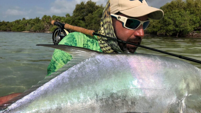 An inshore fly fishermen catches a permit in Ascension Bay, Mexico.